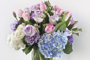 Some of the sentiments expressed by the flowers that are  included in this bouquet express gratitude (hydrangeas), love at first sight (lavendar roses) and admiration (pink roses).